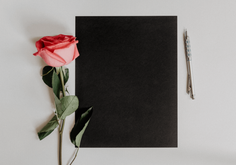 notebook, rose and pen.