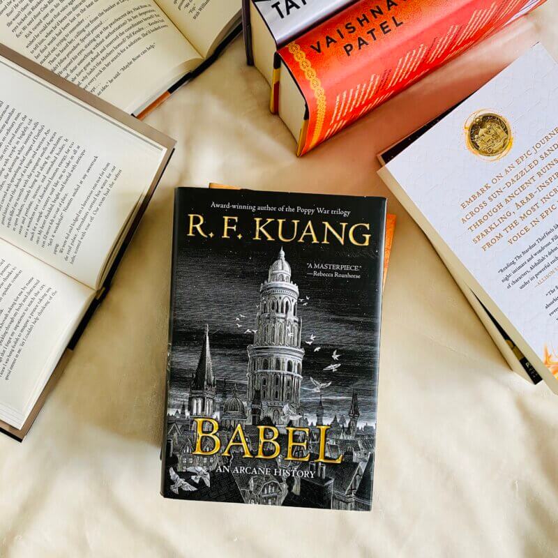 R.F. Kuang's Babel: An Arcane History surrounded by many books