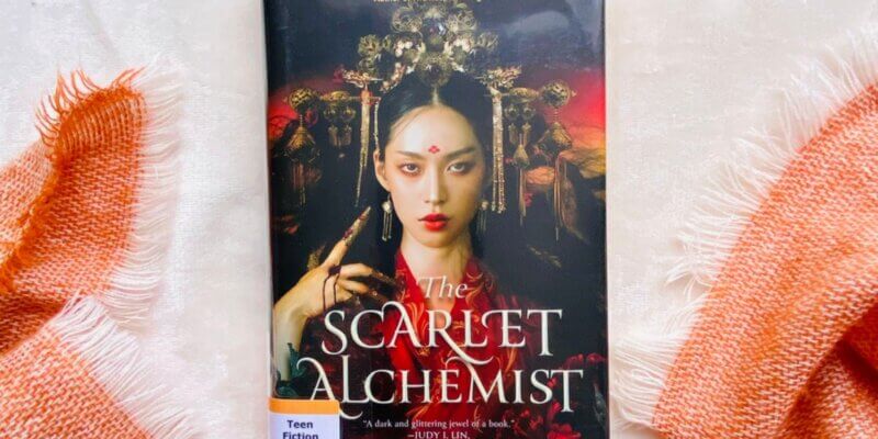 the scarlet alchemist staged around a scarf