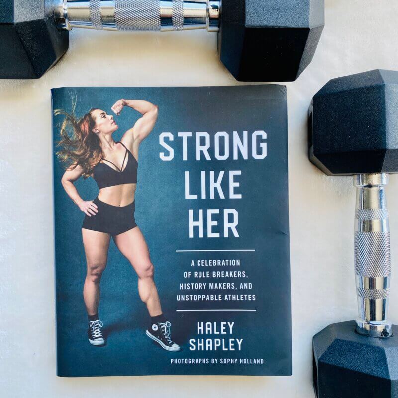 My copy of Strong Like Her with my 12 lbs weights